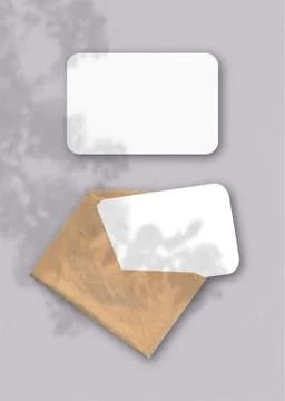 An envelope with two sheets of textured white paper on the grey background of Stock Illustration
