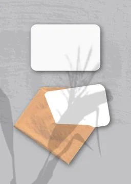 An envelope with two sheets of textured white paper on the gray background of Stock Illustration