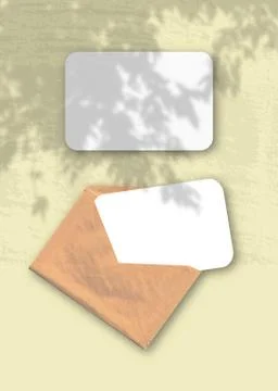 An envelope with two sheets of textured white paper on the yellow background  Stock Illustration