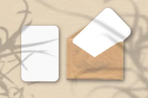 An envelope with two sheets of textured white paper on a orange table backgro Stock Illustration
