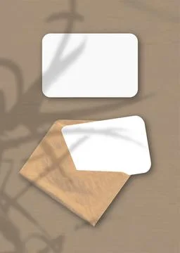 An envelope with two sheets of textured white paper on the brown background o Stock Illustration