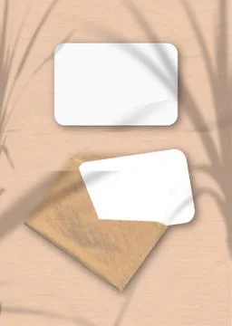 An envelope with two sheets of textured white paper on the pink background of Stock Photos