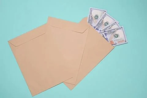 Envelope with us dollar bills on light blue background Stock Photos
