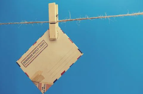 Envelopes of the message on a rope on a blue background. Stock Photos