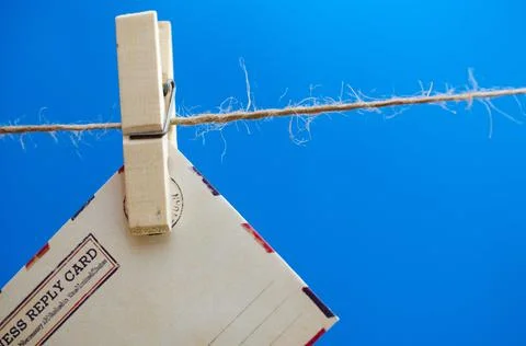 Envelopes of the message on a rope on a blue background. Stock Photos