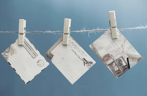 Envelopes of the message on a rope on a blue background. Stock Photos