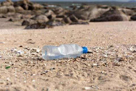 Environment concept trash pollution of plastic bottle on the beach. Stock Photos