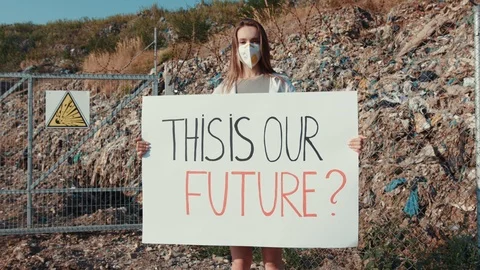 Environment problems concept. Young woman portrait with white poster This is Our Stock Footage 113798551