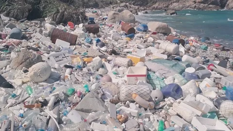 Environmental destruction caused by beach covered in plastic and rubbish Stock Footage