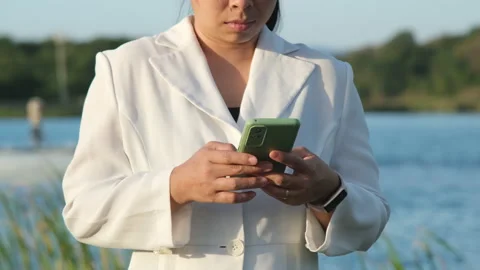 Environmental engineer uses a mobile phone to operate an oxygen turbine aerator. Stock Footage 229704587