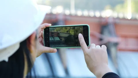 Environmental engineer uses a mobile phone to record data at a dam. Stock Footage 229712518