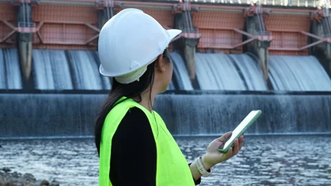 Environmental engineer uses a mobile phone to record water analysis data in dam. Stock Footage 229713771