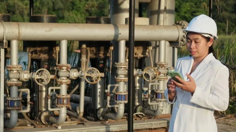 Environmental engineer in white helmet working at wastewater treatment plant. Stock Footage 229705719