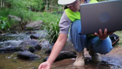 Environmental engineers uses laptop to inspect water quality at natural water. Vídeo Stock 172389993