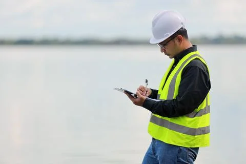 Environmental engineers work at water source to check for contaminants  in .. 스톡 사진