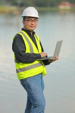 Environmental engineers work at water source to check for contaminants  in .. Stock Photos
