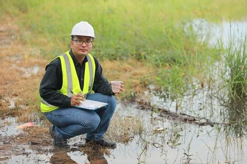 Environmental engineers work at water source to check for contaminants  in .. 스톡 사진