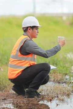 Environmental engineers work at water source to check for contaminants  in .. 스톡 사진