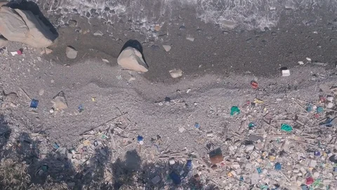 Environmental issues shown by beach covered in plastic and rubbish causing 스톡 동영상 125062346