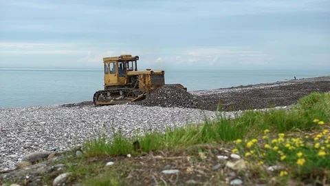 Environmental pollution concept - heavy construction machinery works on seashore Stock Footage 118530175