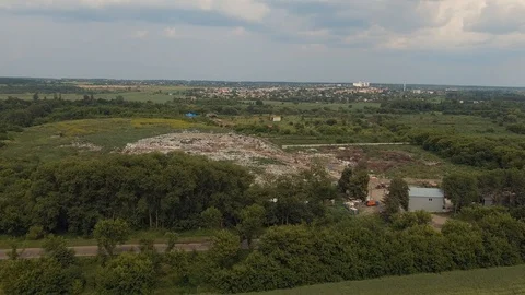 Environmental pollution. Huge city dump of garbage and waste in a green nature Stock Footage 120312445