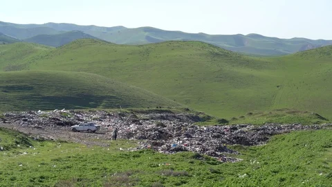 Environmental pollution. People collect garbage in the mountains at the dump Stock Footage 106046846