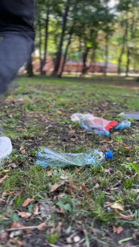 Environmental pollution from person dropping garbage outdoors Stock Footage 329319873