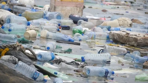 Environmental pollution. Plastic bottles, bags, trash in river or lake Stock Footage