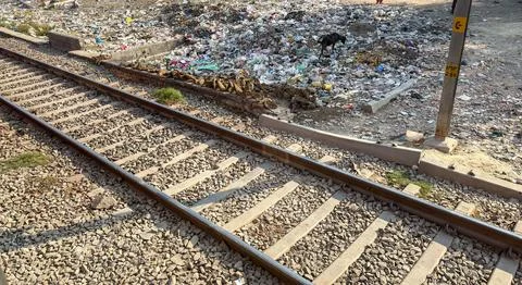 Environmental pollution scene with trash piled near railway line in urban are Stock Photos