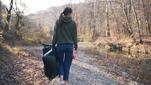 Environmental pollution, volunteering concept. A young woman with a black 動画素材 119988609