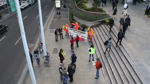 Environmental protesters campaign outside CBA and Westpac Stock Footage 138242724
