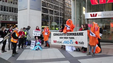 Environmental protesters campaign outside CBA and Westpac Stock Footage 138243062