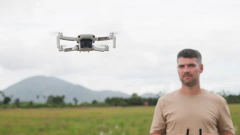 Environmental scientist holds drones remote control. Collecting wildlife data Video stock 322043532