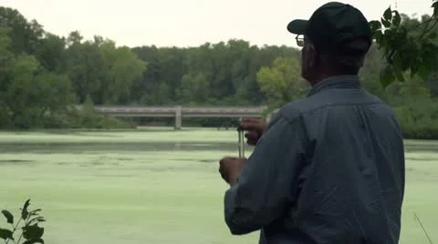 Environmental scientist looking at water sample, silhouette Video stock 12030624