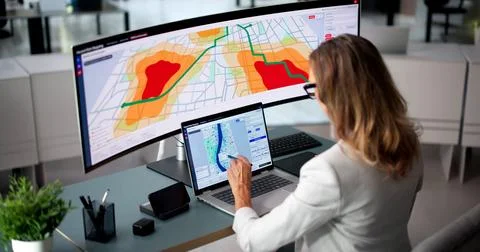 Environmental Scientist Studies Flood Risk Maps Using Advanced Computer Softw 写真素材