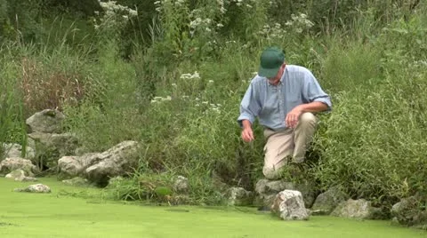 Environmental scientist taking a water sample 스톡 동영상 12030581