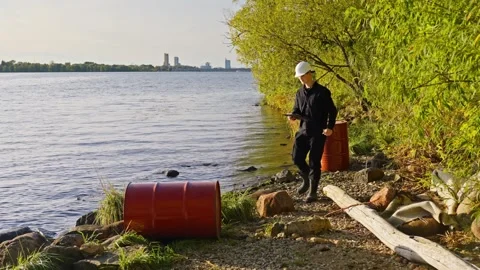 Environmental Scientist Testing Water Quality for Pollution Near Lake Shore Stock Footage 321865626