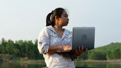Environmentalist analyzing water test results using application on laptop. Stock Footage 241637630