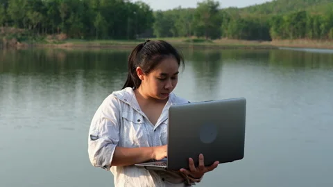 Environmentalist analyzing water test results using application on laptop. Stock Footage 241637688