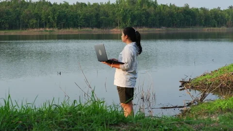 Environmentalist analyzing water test results using application on laptop. Stock Footage 241637763