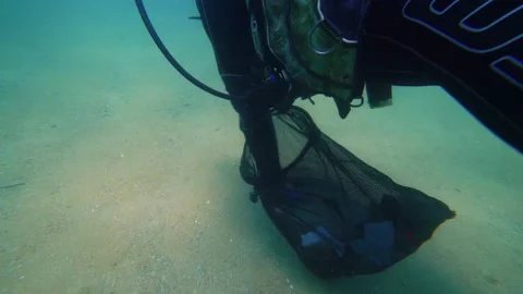 Environmentalist Scuba Diver Puts Plastic Into the Bag Underwater, 4k Stock Footage 144836220