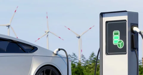 Environmentally friendly electric car charging on background of windmills. Sunny Stock Footage 196205259