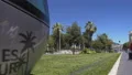 Environmentally friendly tram running around big city on track lined with grass 4k or 4k+ Resolution