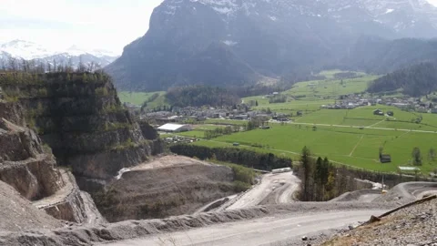 Environmentally harmful quarry next to a beautiful swiss mountain landscape Stock Footage 182767142