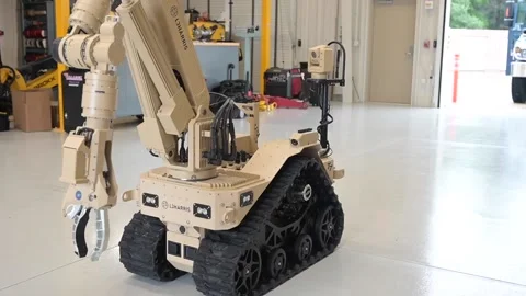 EOD L3Harris multi-mission robot travelling through workshop Stock Footage 209546803