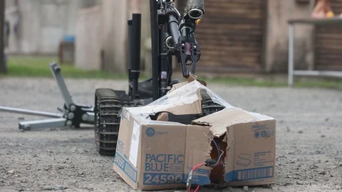EOD robot, The Talon, opening box with suspect improvised explosives device Stock Footage 103513385