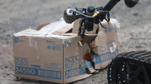 EOD robot, The Talon, opening box with suspect improvised explosives device Stock Footage 103513449