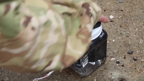 EOD soldier placing screw cap on improvised explosive device Stock Footage 111947821