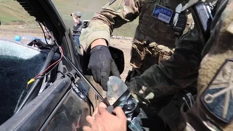 EOD soldiers attach improvised explosive device to vehicle during IED training Stock Footage 111947867