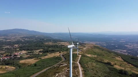 Eolic generators spining with the wind in the mountains on a sunny day Stock Footage 209872450